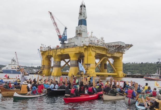 Activists participate in the sHell No Flotilla part of the 'Paddle in Seattle' protest.  Nearly a thousand people from the country gathered in Seattle's Elliott Bay for a family-friendly festival and on-land rally to protest against Shell's Arctic drilling plans.