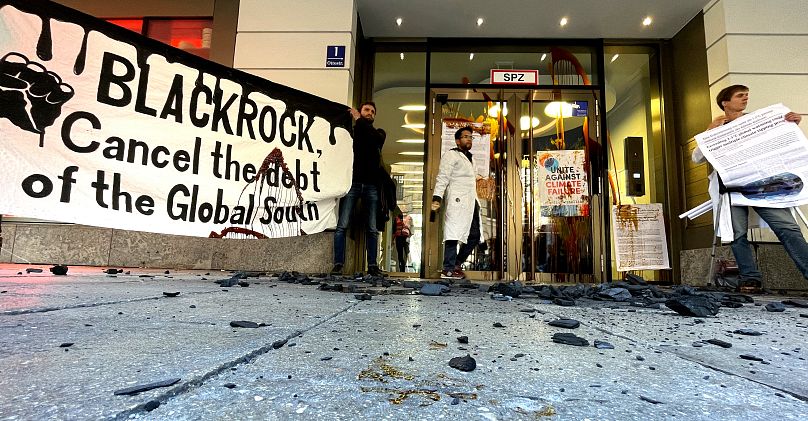 İklim değişikliği grubu Scientist Rebellion aktivistleri, 25 Ekim 2022'de Almanya'nın Münih kentindeki Blackrock binasının önünde protesto gösterisi yapıyor.