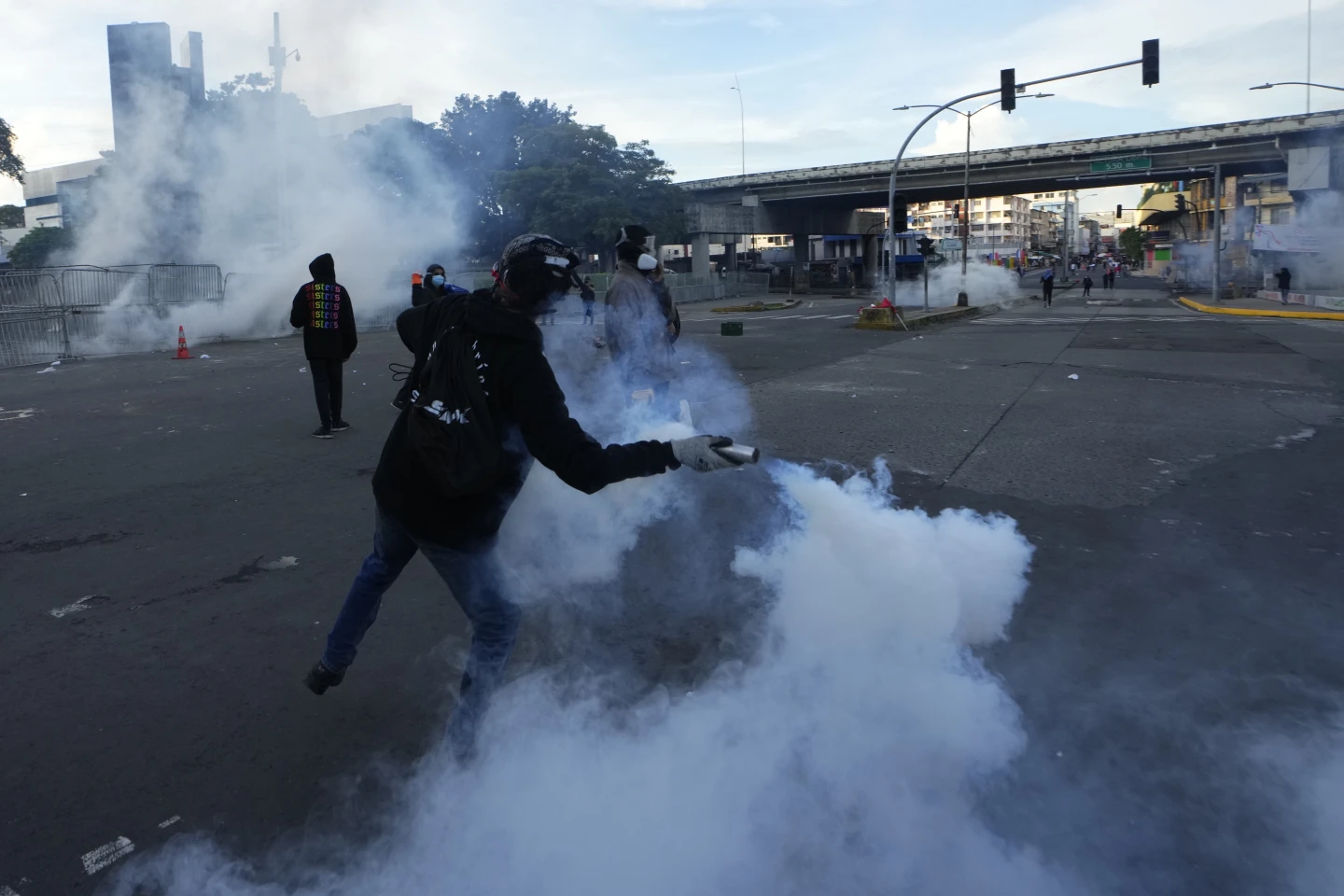 Fotoğraf, polisin göstericilere attığı biber göz yaşartıcı gazı polislere geri atan bir eylemciyi gösteriyor. - Fotoğraf: Arnulco Franco / AP Photo